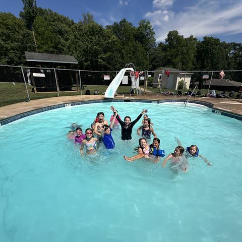 Campers swimming in the pool