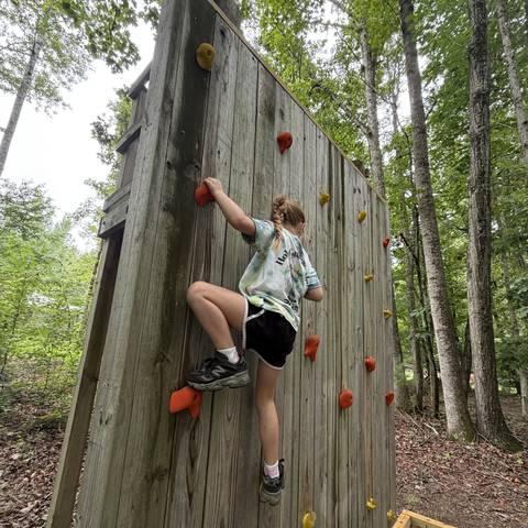 Camper climbing the rock wall