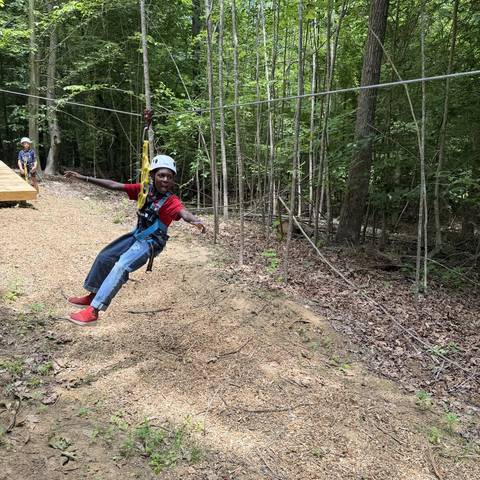 Camper riding the zip line