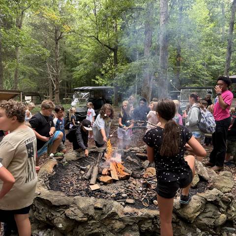 Campers gathered around the campfire