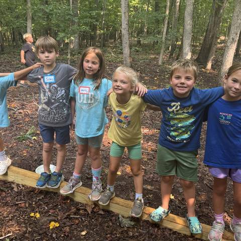 Campers standing on a balance log