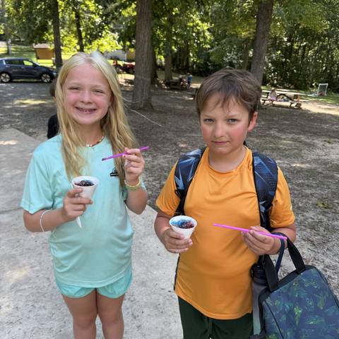 Two campers with snacks