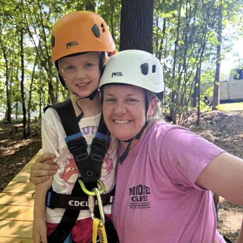 Camper and counselor in climbing helmets