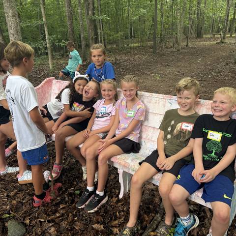 Campers sitting together on a bench