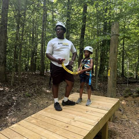 Counselor and camper on the wooden bridge