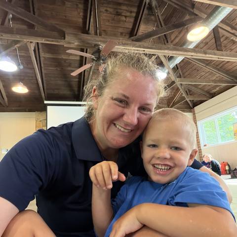 Counselor and camper smiling