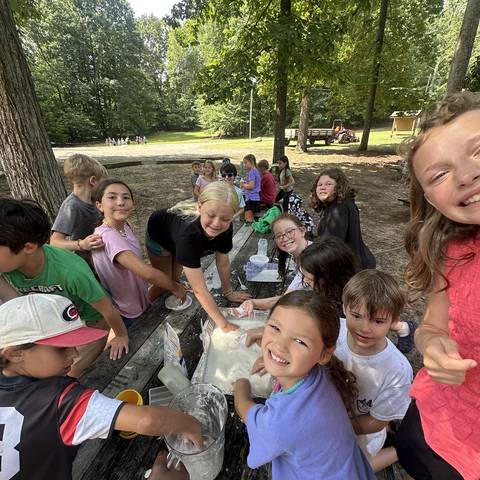 Campers sitting together for a snack
