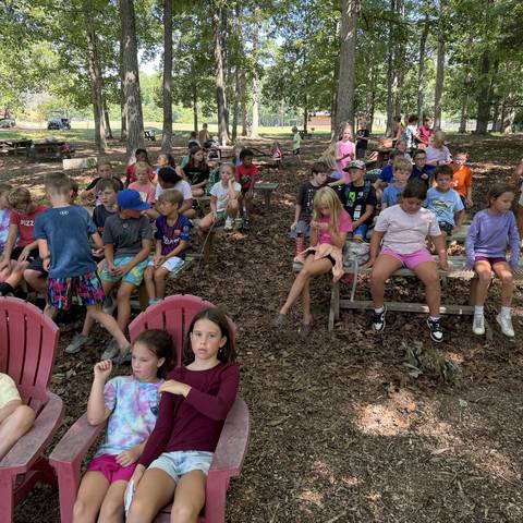 Campers seated in the outdoor chapel