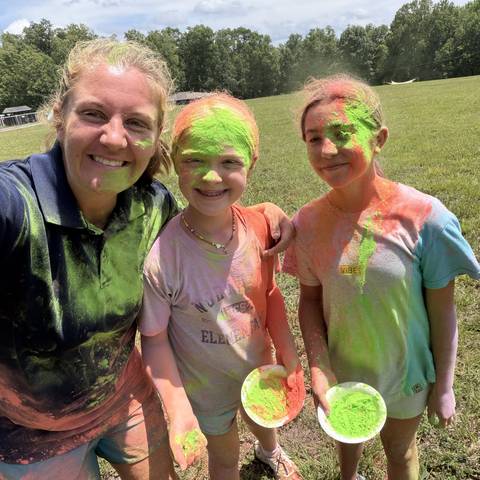 Counselor and campers with face paint