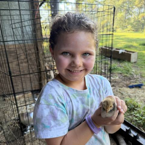 Camper holding a small animal